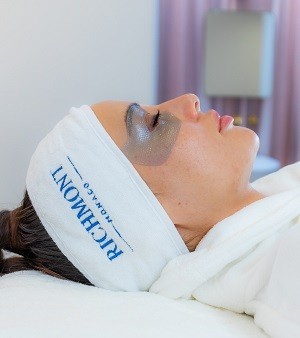Woman having a facial treatment with a facial mask at Richmont Monaco